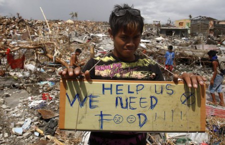 Little boy standing in the middle of the devastation asking for food. https://ph.news.yahoo.com/media-workers-among--yolandaph-dead-103157454.html 